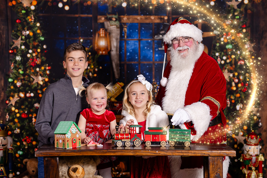 siblings sharing a photo session with Santa in Raleigh North Carolina